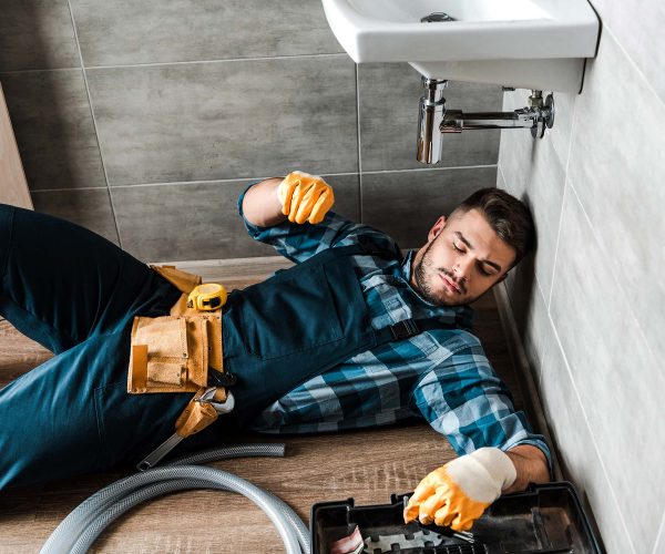 bearded-handyman-lying-on-floor-near-toolbox-in-ba-resize.jpg